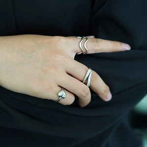 Minimalist silver heart and double wave open rings for women on a dark suit background