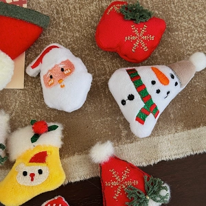 DIY Christmas felt embroidery patches featuring Santa, snowman, and stocking for crafts
