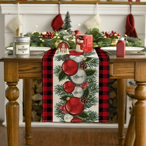Close-up of Christmas table runner featuring red buffalo plaid and holiday pine cone motifs