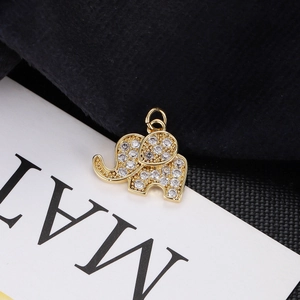 Macro shot of a golden elephant pendant set with sparkling white cubic zirconia