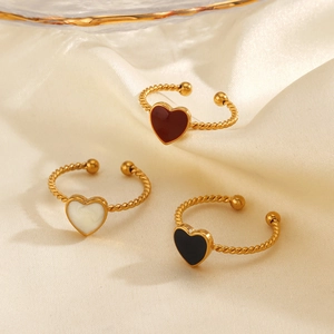 Three gold twisted heart open rings in red white and black enamel on beige satin