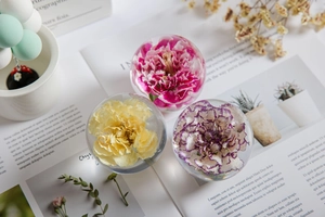Detailed view of dried flower crystal ball ornaments placed on an open magazine