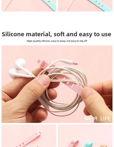 Close-up of pink and blue silicone cable ties securing white earphones neatly