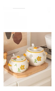 Ceramic lard storage jar set with yellow daisy pattern including matching lids and spoons