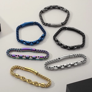 Flat lay of stainless steel curb chains in six colors including gold, black, and silver