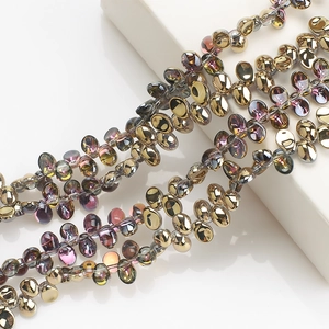 Detailed view of iridescent gold and purple crescent glass crystal beads for DIY jewelry