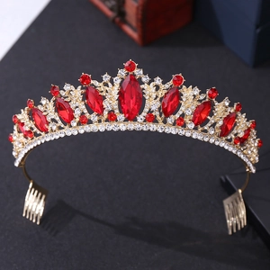 Detail of gold bridal crown with red gemstones, clear rhinestones and side combs