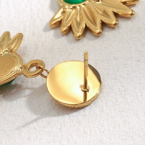Macro shot of 18K gold-plated sunflower earrings with green gemstone inlay details