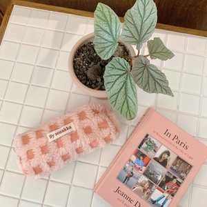 Detail of pink and white checkered plush stationery bag with soft waffle texture