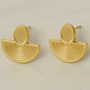 Detail of vintage gold fan earrings with yellow stones and textured steel finish
