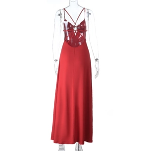 Detail view of the back of a red backless maxi dress with cross strap design