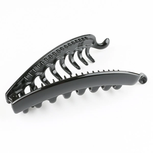 Detail of a large black plastic banana hair clip with internal comb teeth on white background