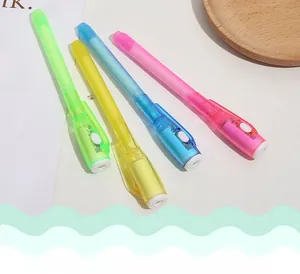Set of four colorful UV invisible ink pens with built-in LED lights on a desktop tray