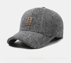 Close-up of winter grey baseball cap with textured wool fabric and brown leather patch