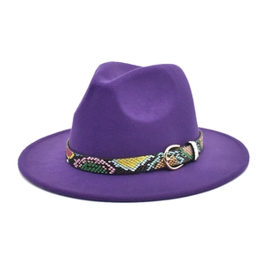 Detail of purple wool fedora hat featuring a snakeskin belt and gold buckle