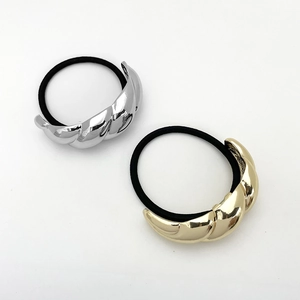 Detailed view of gold and silver U-shaped metal twist hair ties with black elastic bands