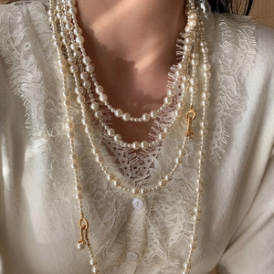 Elegant multi-layer pearl necklace with vintage gold clasp for a sophisticated look