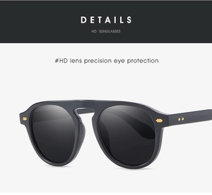 Detail of high-definition lenses and golden rivet accents on chic black frame sunglasses