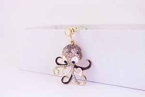 Detailed view of turtle keychain featuring gold metal plating and sparkling grey rhinestones