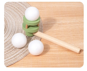 Detail view of a wooden floating ball game pipe with three lightweight foam balls