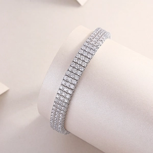Detailed close-up of a three-row silver tennis bracelet featuring micro-pave cubic zirconia