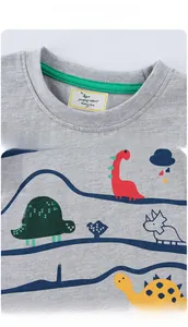 Detail of grey cotton boy's t-shirt showing green neckline trim and dinosaur prints