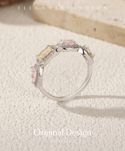 Detail of S925 silver ring with pink and yellow candy-colored gemstones on stone base