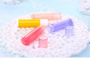Detailed view of colorful 5g plastic lip balm tubes in pink, yellow, purple and clear finish