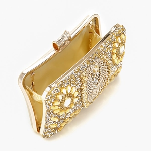 Detailed top view of gold evening clutch with flower rhinestones and chain strap