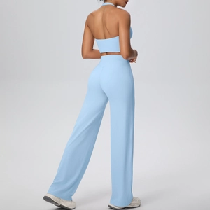 Detail view of the open-back sports top and high-waist loose yoga pants in light blue