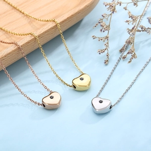 Detailed view of heart pendants in rose gold, gold and silver with black gemstones