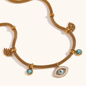 Detailed view of evil eye necklace with turquoise beads and 18K gold plated mesh chain