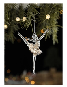 Detail of ballet dancer Christmas ornament with gold sequins hanging on pine branch