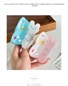 Detailed view of butterfly claw clips showing dimensions and acetate material texture