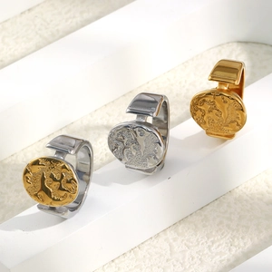 Macro shot of world map relief on oval rings in gold and silver finishes