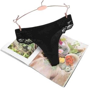 Elegant black lace thong with rose gold metal hooks displayed on a magazine