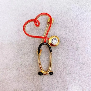 Creative stethoscope heart brooch with red enamel and sparkling crystal accents