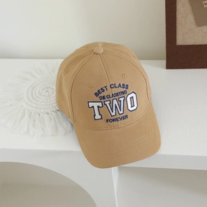 Detail of khaki cotton baseball cap featuring blue and white TOW embroidery design