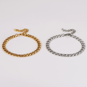 Detail of 8mm wide Cuban link anklets in polished gold and silver stainless steel
