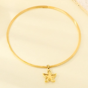 Golden starfish pendant necklace on silk backdrop, stainless steel ocean style jewelry