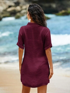 Detail of burgundy textured short sleeve shirt dress back view with rolled cuffs
