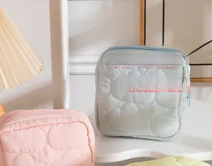 Detailed macro view of quilted cloud texture and zipper on macaron color storage bags