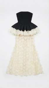 Detail view of monochrome tube dress with 3D floral petals and tiered fishtail hem