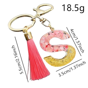Pink tassel keychain with letter S golden glitter resin pendant and dimensions measurements