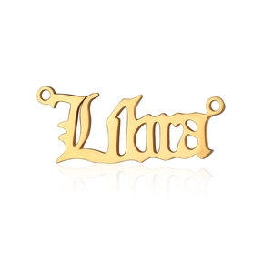 Macro shot of golden stainless steel Libra zodiac charm in gothic style font with side loops