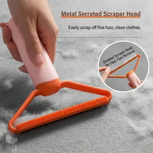 Manual lint remover tool for clothes with metal serrated head and pink handle