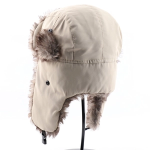 Detail view of khaki winter trapper hat with dark brown faux fur lining and buckle strap