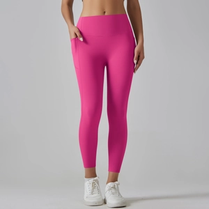 Detail of high waist yoga leggings with side pockets in bright pink stretch fabric