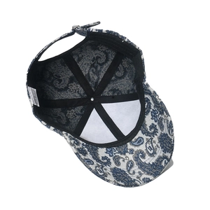 Internal view of blue paisley baseball cap showing sweatband and metal adjustable buckle