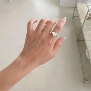 Close-up of S925 silver heart-shaped zircon ring worn on a finger for style display